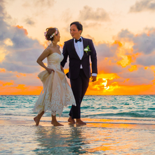 Just Validly Married Sign on the back of
a red car. Decorated with swathes of cream
tulle, and white flowers