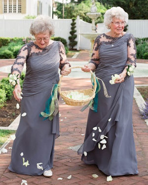 Grandma flower girls
wearing matching slate blue gowns and scattering
white rose petals
