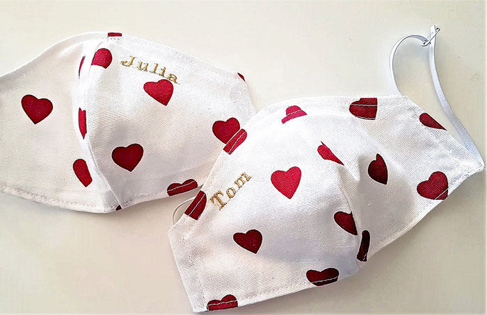 white masks printed with red hearts and
embroidered names